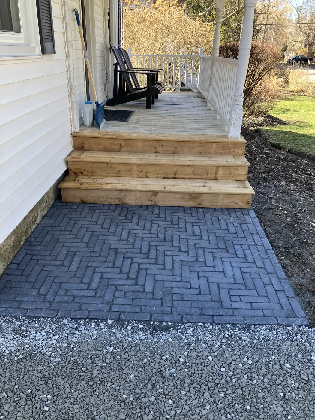 Herringbone paver landing with new wood steps at the side of a Hamilton home